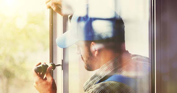 un vitrier en train de travailler sur une fenetre